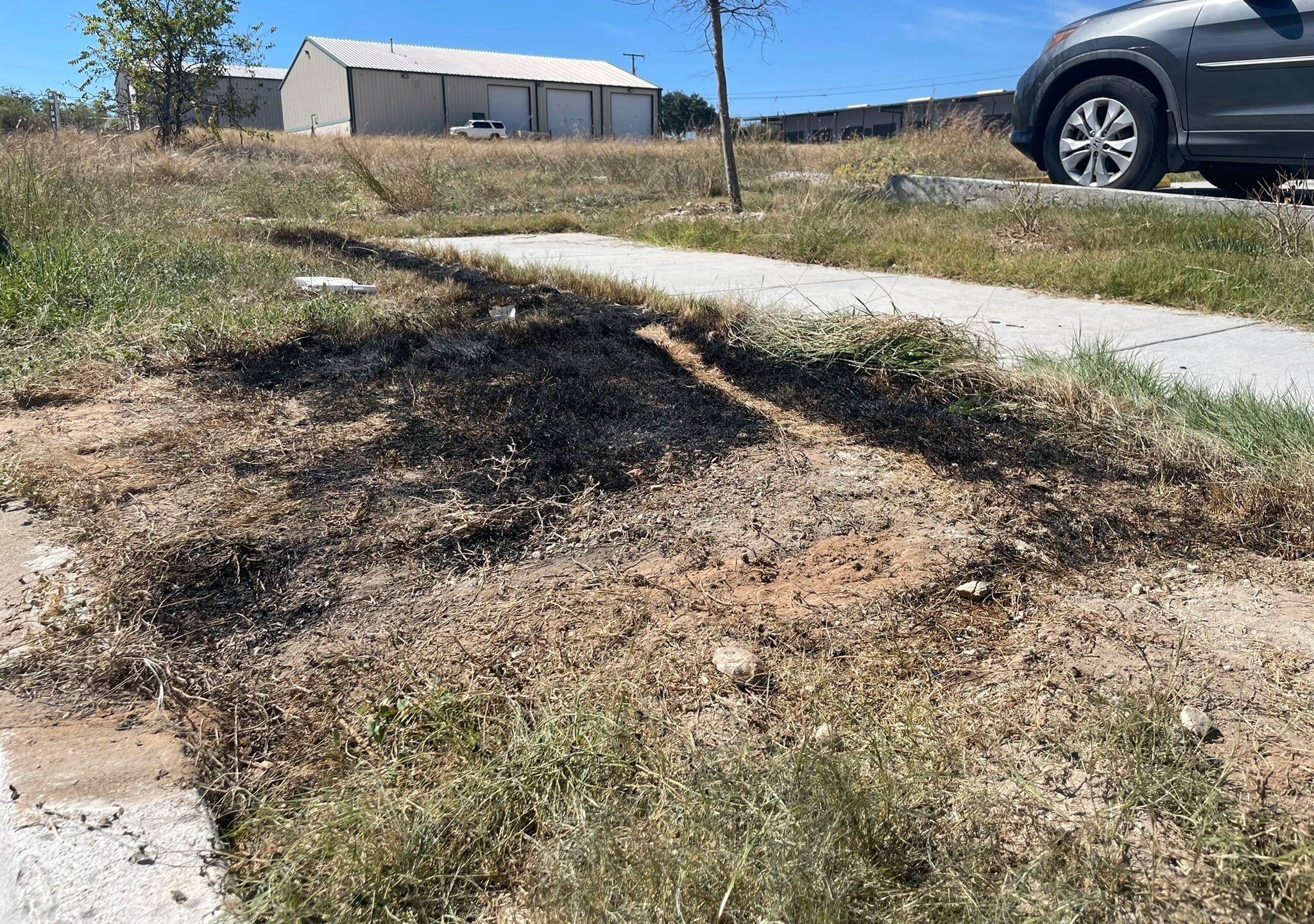 This Sept. 24, 2021 photo provided by Jason Allen and KTVT, shows the spot in Fort Worth, Texas, where a dumpster was on fire that had dismembered bodies inside. Police said the bodies appeared to be those of a man, a teen girl or adult woman, and a child. As of Monday, Sept. 27, 2021, authorities had identified only the man. Police have said the identification process has been difficult because of the condition of the bodies. (Jason Allen/KTVT via AP)