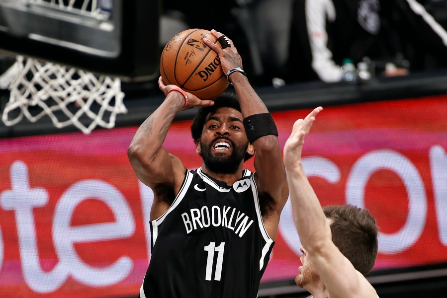 Brooklyn Nets guard Kyrie Irving (11) shoots against the Milwaukee Bucks during the second half of Game 1 of an NBA basketball second-round playoff series in New York, in this June 5, 2021, file photo. Players like Kyrie Irving, who has refused to say if he will be vaccinated against COVID-19, will be subject to testing on all NBA practice, travel and game days this season. (AP Photo/Adam Hunger, File)