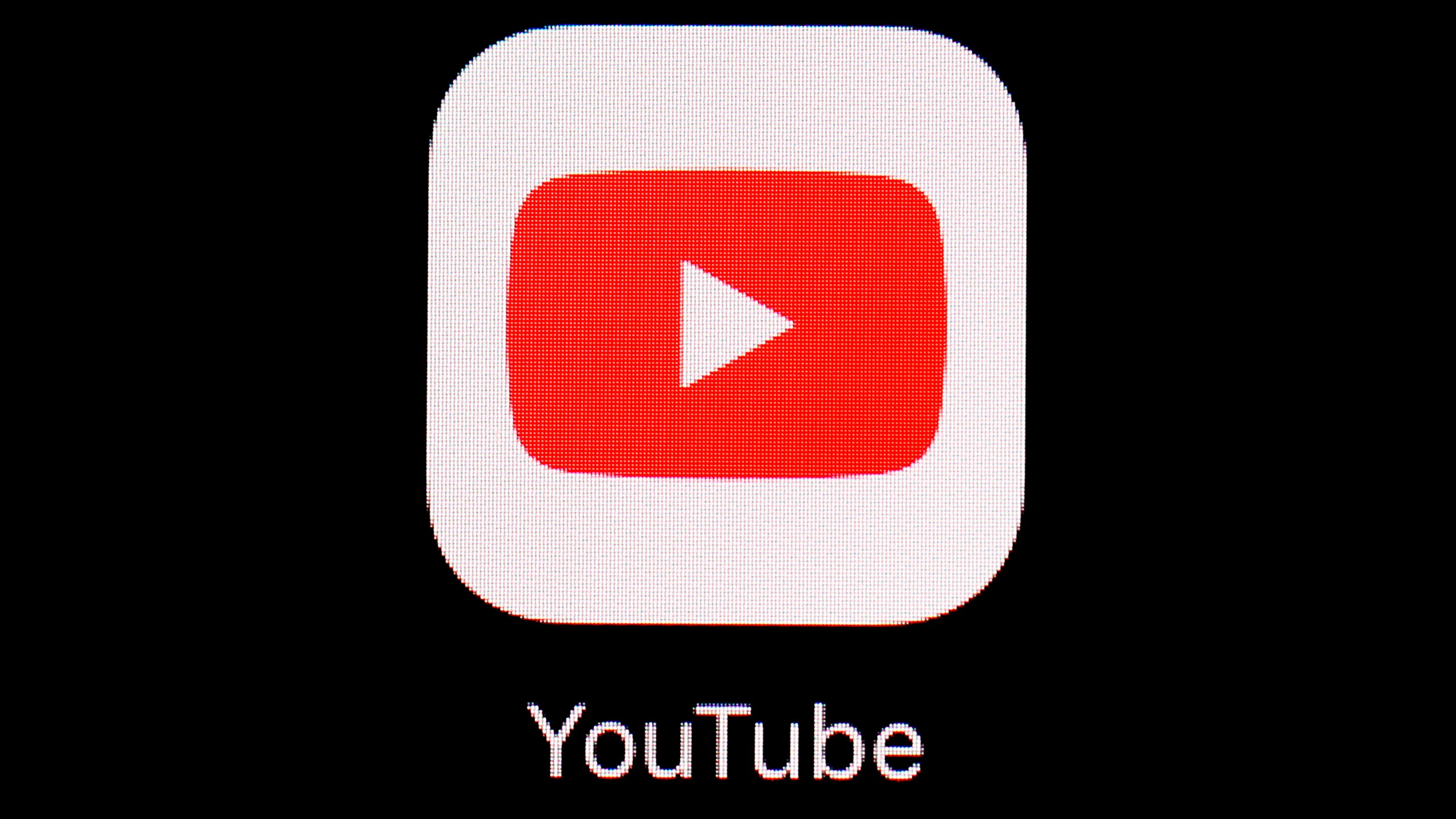 This March 20, 2018, file photo shows the YouTube app on an iPad in Baltimore. Video-sharing tech platform YouTube on Wednesday, Sept. 29, 2021, announced immediate bans on false claims that vaccines are dangerous and cause health issues like autism, cancer or infertility. (AP Photo/Patrick Semansky, File)