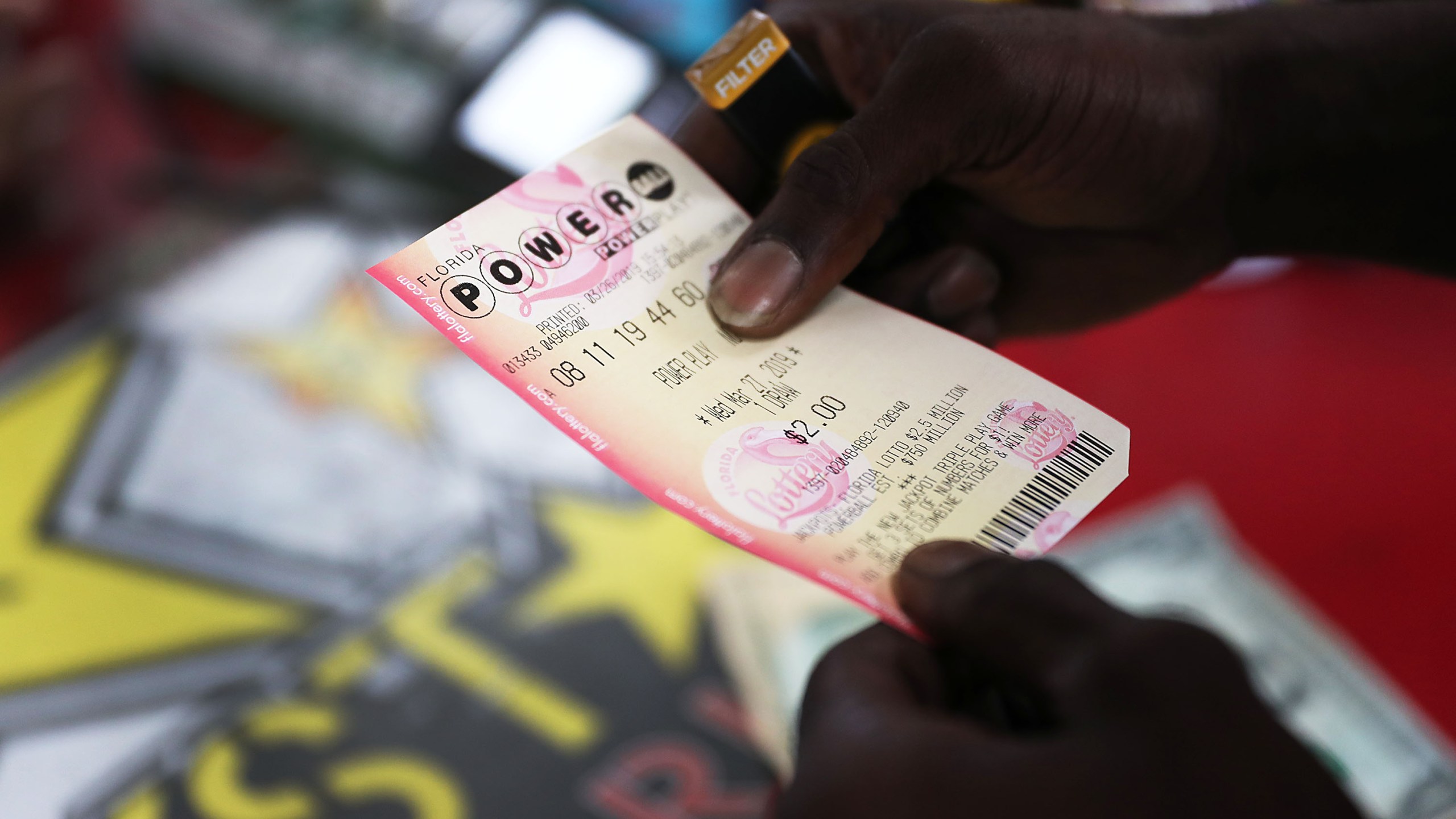 George Hollins buys a Powerball ticket at the Shell Gateway store on March 26, 2019 in Boynton Beach, Florida. (Joe Raedle/Getty Images)