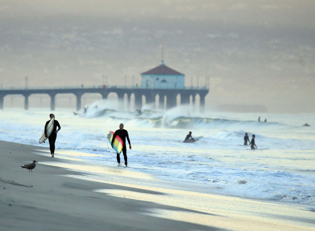 Surfers look to hit the water during the early morning hours at El Porto Beach on December 11, 2019 in Manhattan Beach, California. (Bruce Bennett/Getty Images)