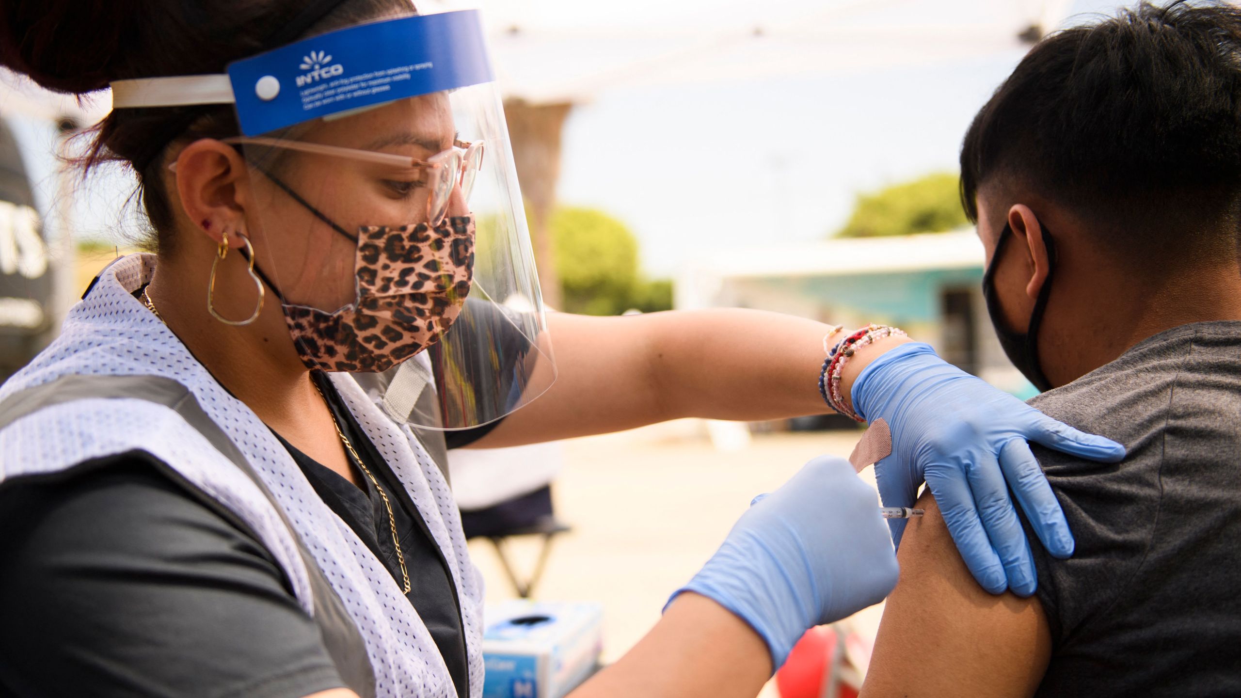 A 17-year-old receives a first dose of the Pfizer COVID-19 vaccine at a mobile vaccination clinic during a back to school event at the Weingart East Los Angeles YMCA in Los Angeles on Aug. 7, 2021. (PATRICK T. FALLON/AFP via Getty Images)