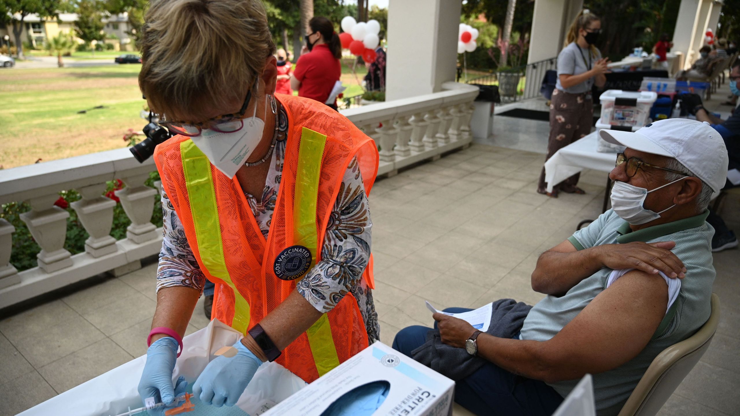 A nurse prepares a first dose of the Pfizer COVID-19 vaccine for Jose Luis Sanchez at a clinic hosted by The Tournament of Roses in partnership with the Pasadena Public Health Department on Aug. 19, 2021, at Tournament House in Pasadena. (Robyn Beck / AFP / Getty Images)