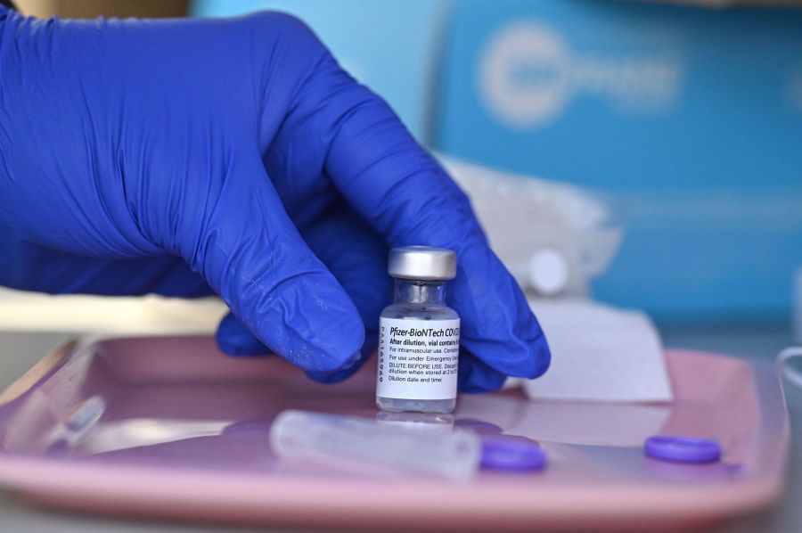 A nurse reaches for a vial of Pfizer-BioNTech Covid-19 vaccine at a pop up vaccine clinic in Arleta on Aug. 23, 2021. (ROBYN BECK/AFP via Getty Images)