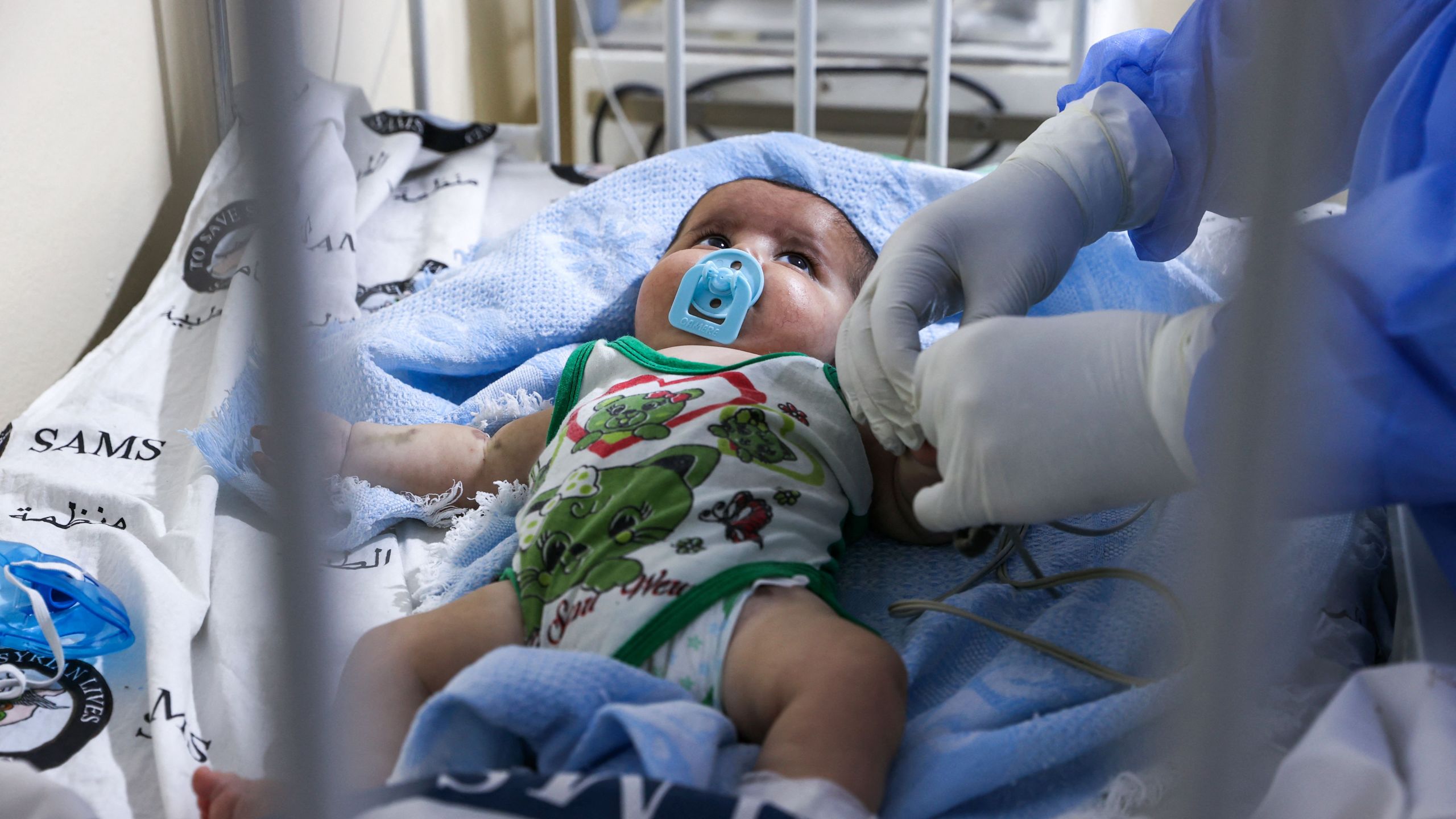 A medic cares for a baby at a COVID-19 isolation ward, in Syria, on Sept. 5, 2021. (OMAR HAJ KADOUR/AFP via Getty Images)