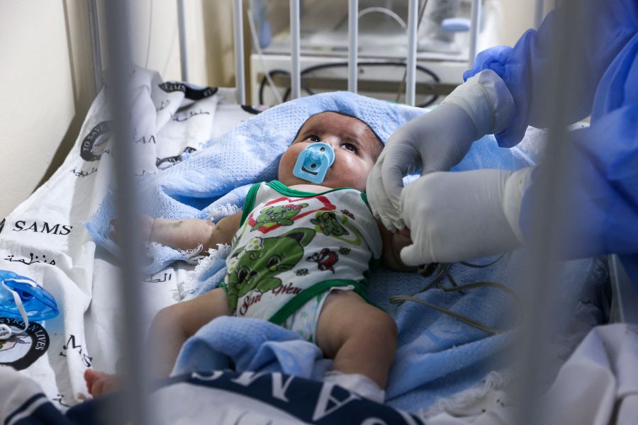 A medic cares for a baby at a COVID-19 isolation ward, in Syria, on Sept. 5, 2021. (OMAR HAJ KADOUR/AFP via Getty Images)