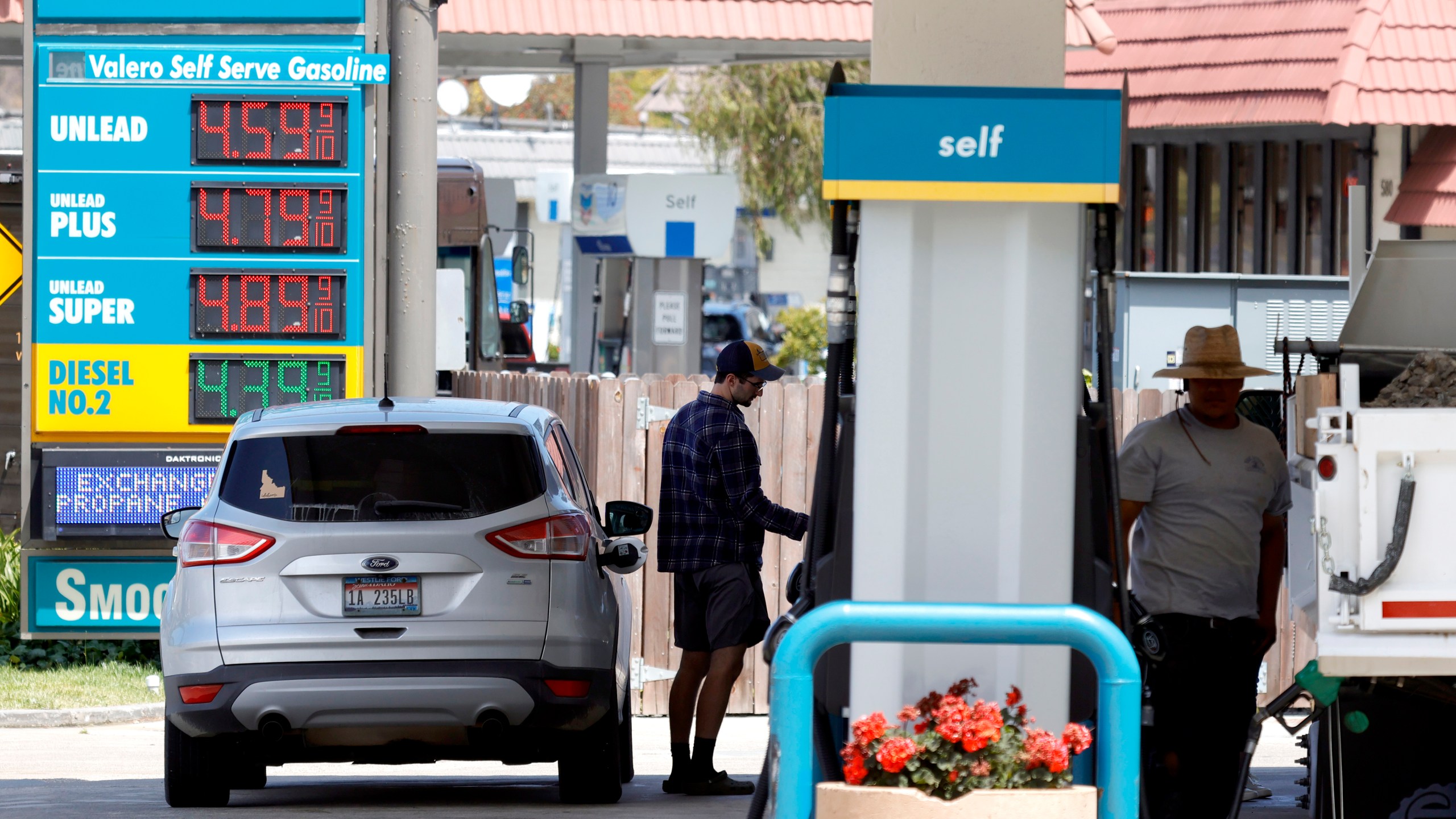 A customer prepares to pump gasoline into his car at a Valero station on July 12, 2021 in Mill Valley, California. (Justin Sullivan/Getty Images)