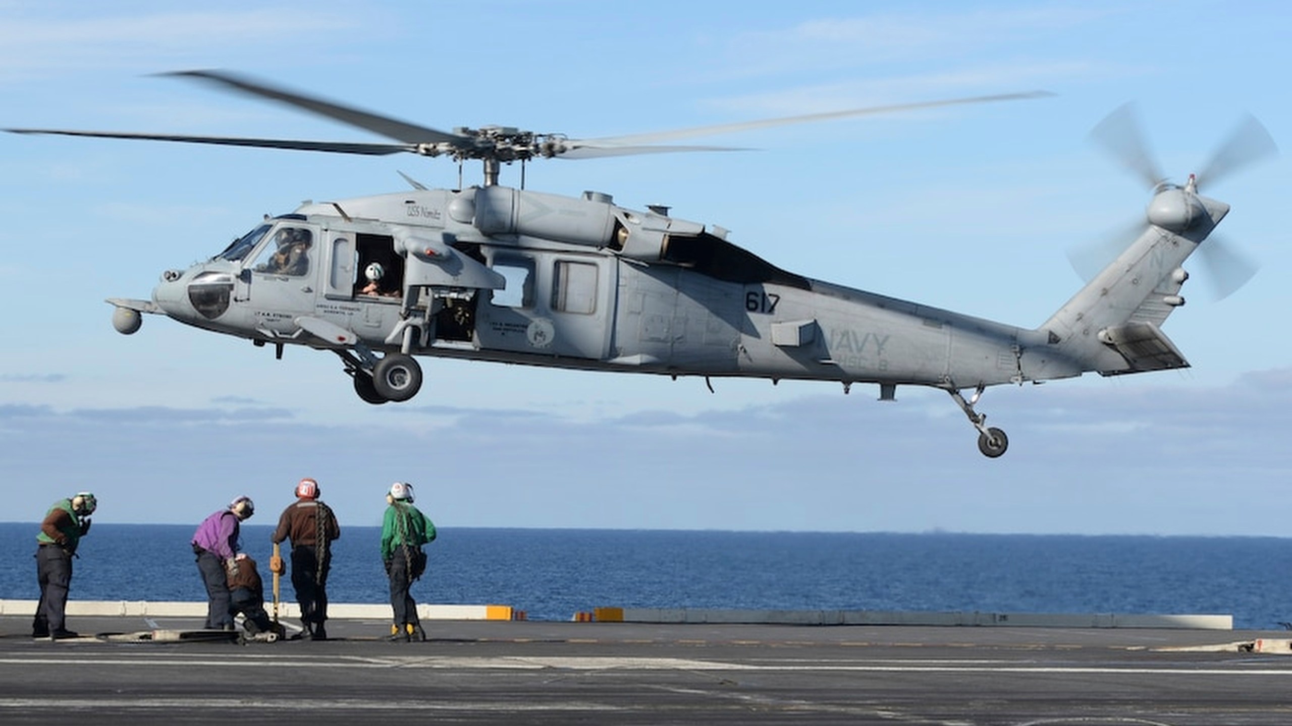 In this March 19, 2017 file photo released by the U.S. Navy, an MH-60S Sea Hawk helicopter prepares to land on the flight deck of the aircraft carrier USS Nimitz in the Pacific Ocean. (Mass Communication Specialist Seaman Ian Kinkead/U.S. Navy via AP)