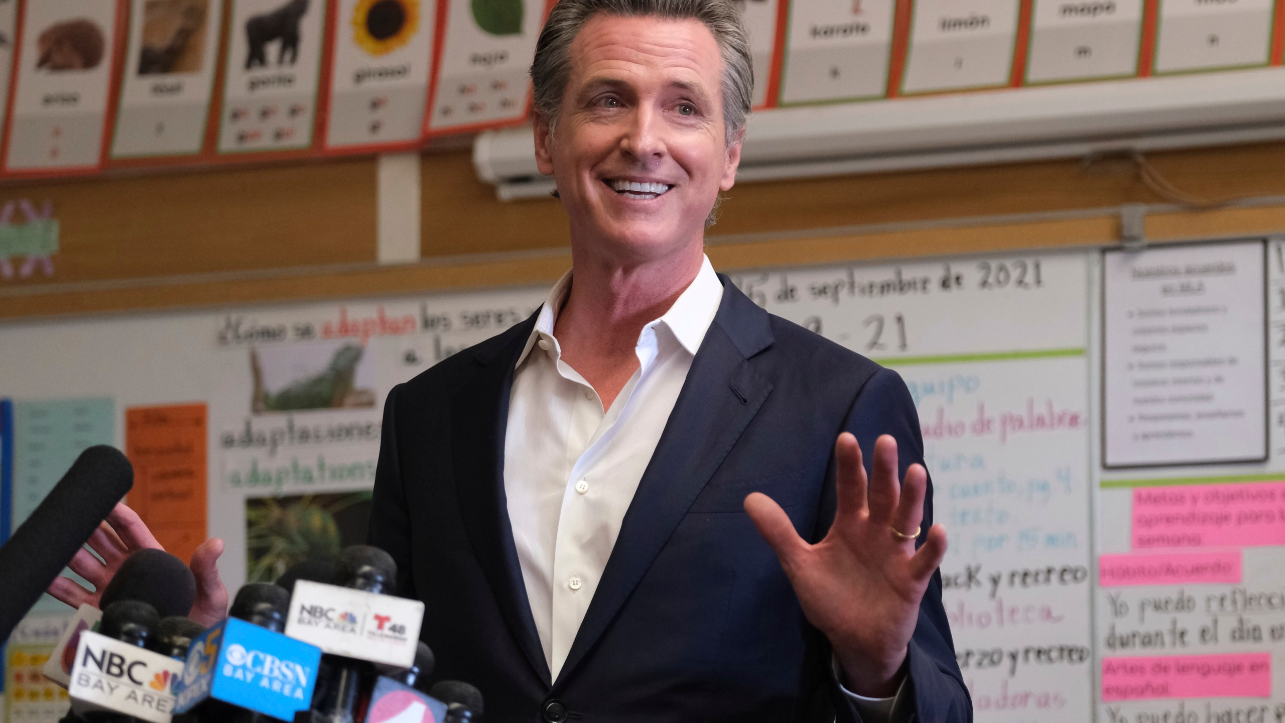 Gov. Gavin Newsom speaks to the press after visiting with students at Melrose Leadership Academy, a TK-8 school in Oakland, Calif., on Wednesday, Sept. 15, 2021, one day after defeating a Republican-led recall effort. (AP Photo/Nick Otto)