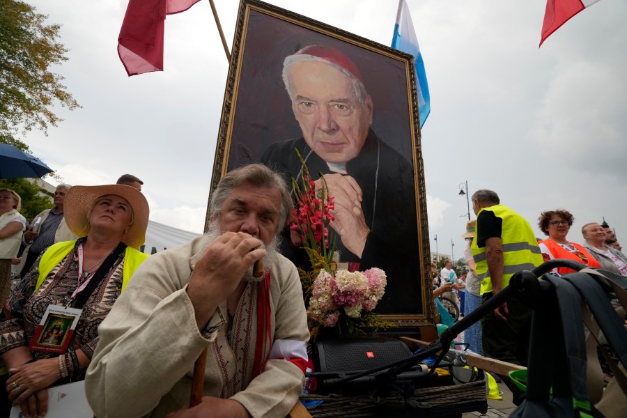 Catholic faithful attend the beatification ceremony of Polish Cardinal Stefan Wyszynski and Mother Elzbieta Roza Czacka in front of the church of Providence in Warsaw, Poland, Sunday, Sept. 12, 2021. Poland's top political leaders gathered in a Warsaw church Sunday for the beatification of two revered figures of the Catholic church — a cardinal who led the Polish church's resistance to communism and a blind nun who devoted her life to helping others who couldn't see. (AP Photo/Czarek Sokolowski)