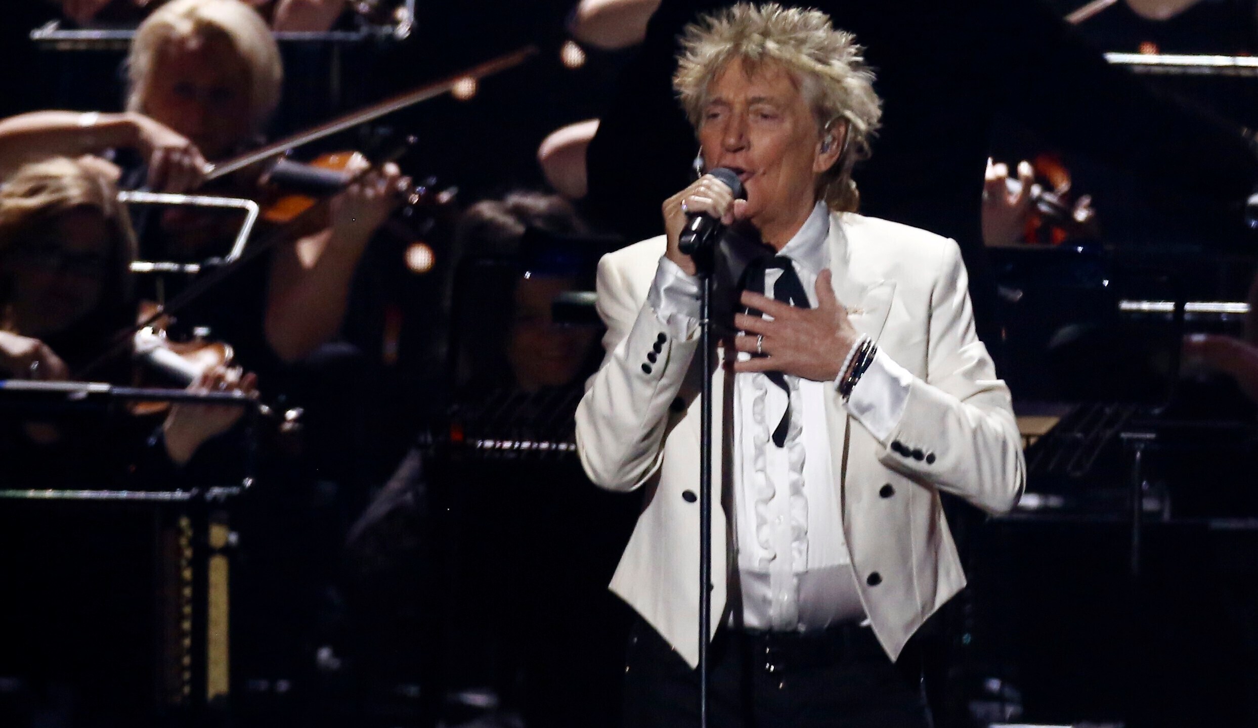 In this Feb. 18, 2020 file photo, Rod Stewart performs on stage at the Brit Awards 2020 in London. A Florida judge on Thursday, Sept. 9, 2021, has canceled the trial for Stewart and his adult son and scheduled a hearing next month to discuss a plea deal to resolve misdemeanor charges. The singer of 70s hits such as “Da Ya Think I’m Sexy?” and “Maggie May” and his son are accused of pushing and shoving a security guard at an upscale hotel because he wouldn’t let them into a New Year’s Eve party nearly two years ago. (Joel C Ryan/Invision/AP)