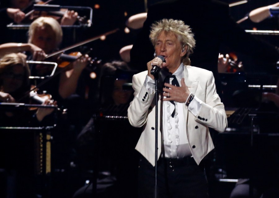 In this Feb. 18, 2020 file photo, Rod Stewart performs on stage at the Brit Awards 2020 in London. A Florida judge on Thursday, Sept. 9, 2021, has canceled the trial for Stewart and his adult son and scheduled a hearing next month to discuss a plea deal to resolve misdemeanor charges. The singer of 70s hits such as “Da Ya Think I’m Sexy?” and “Maggie May” and his son are accused of pushing and shoving a security guard at an upscale hotel because he wouldn’t let them into a New Year’s Eve party nearly two years ago. (Joel C Ryan/Invision/AP)