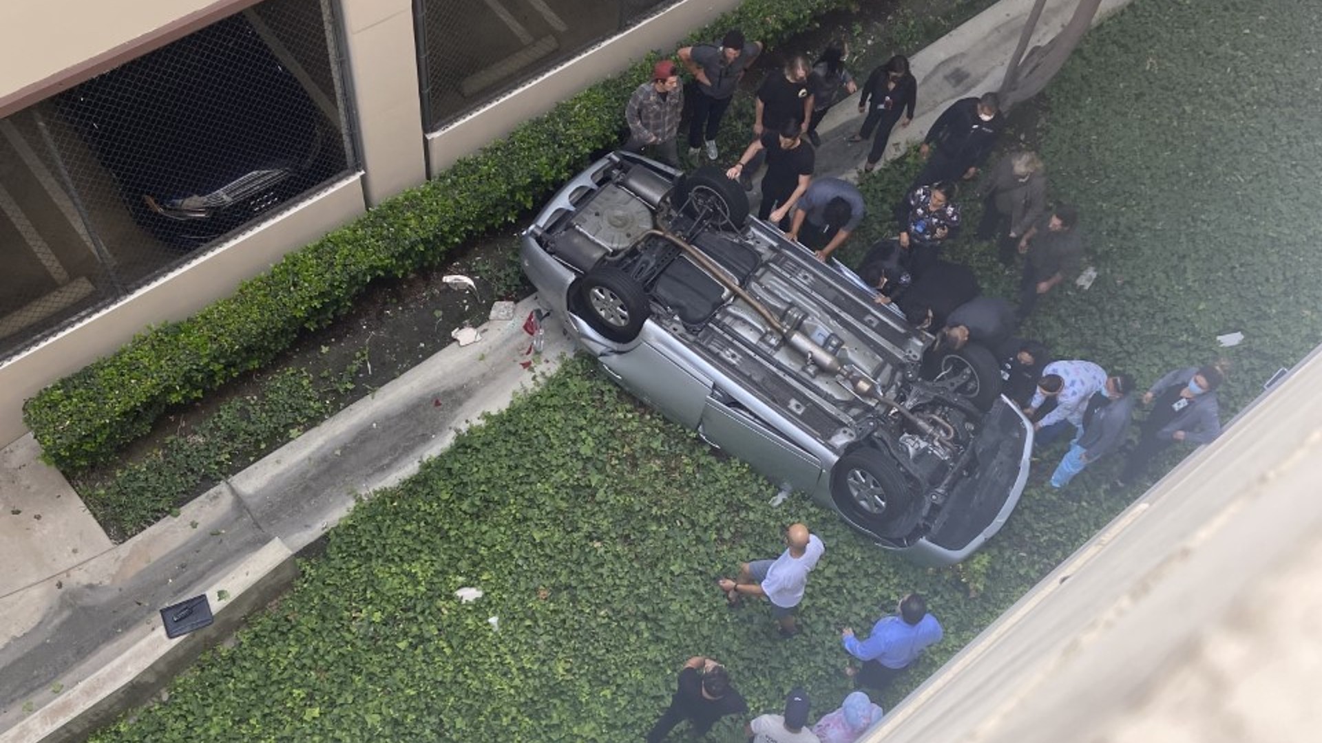 A photo submitted by a KTLA viewer showed more than a dozen people surrounding the car before the citizens were able to turn it back over.