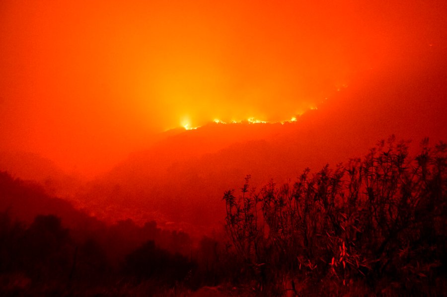 Flames from the KNP Complex Fire burn along a hillside above the Kaweah River in Sequoia National Park, Calif., on Tuesday, Sept. 14, 2021. (AP Photo/Noah Berger)