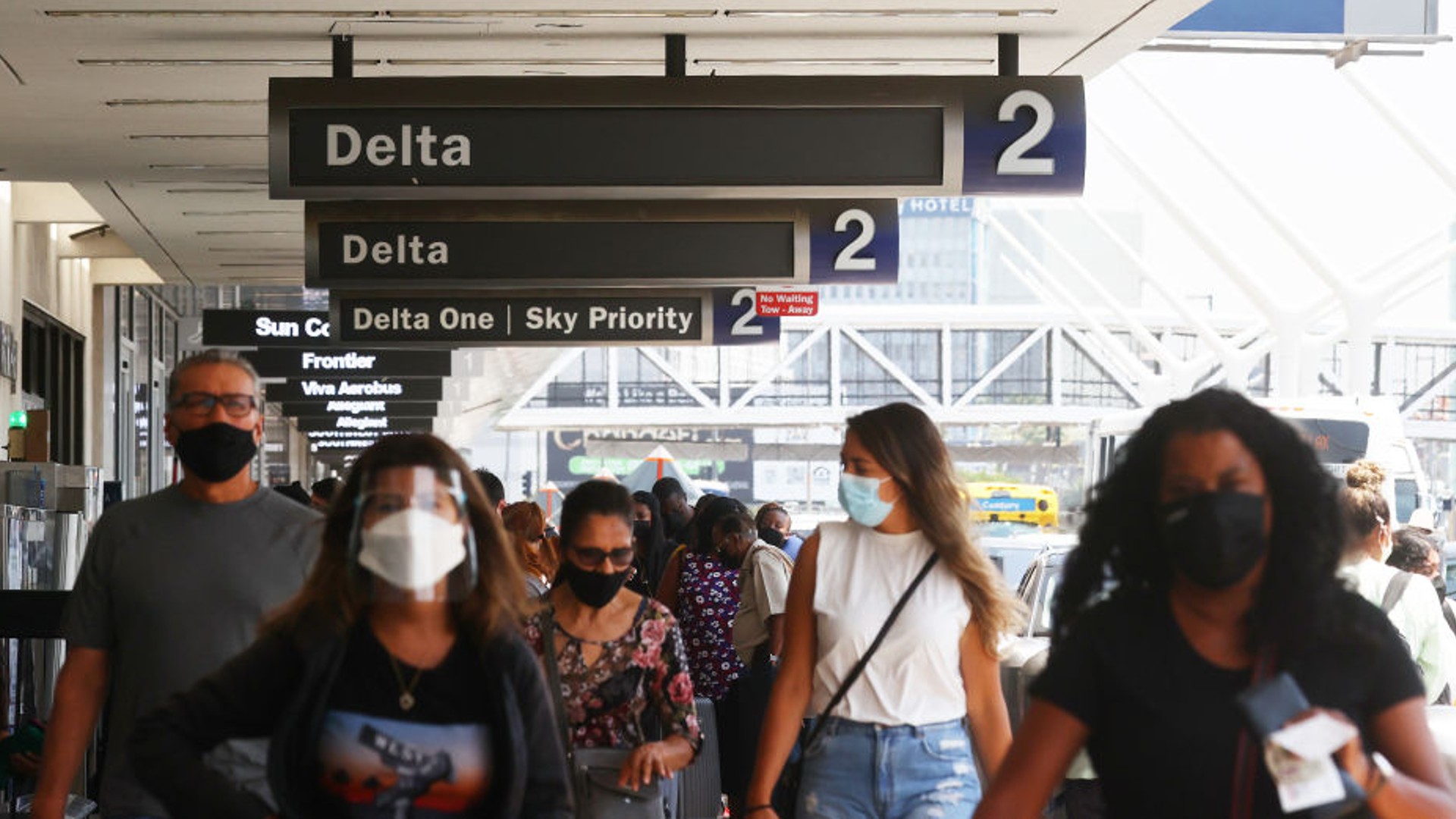 People gather outside the Delta Air Lines departures level at Los Angeles International Airport on August 25, 2021. (Mario Tama/Getty Images)