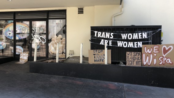 Signs are placed outside the Wi Spa in Koreatown in July, 2021. (Adam Elmahrek / Los Angeles Times)