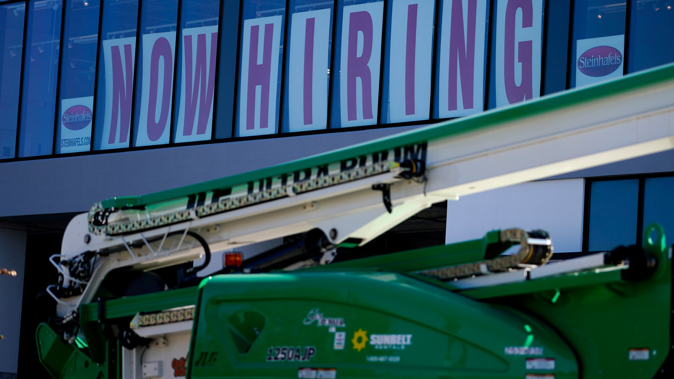 A hiring sign is displayed at a furniture store window on Friday, Sept. 17, 2021, in Downers Grove, Ill. Unemployment claims dropped 6,000 to 290,000 last week, the third straight drop, the Labor Department said Thursday, Oct. 21, 2021,. That’s the fewest people to apply for benefits since March 14, 2020, when the pandemic intensified. (AP Photo/Nam Y. Huh)