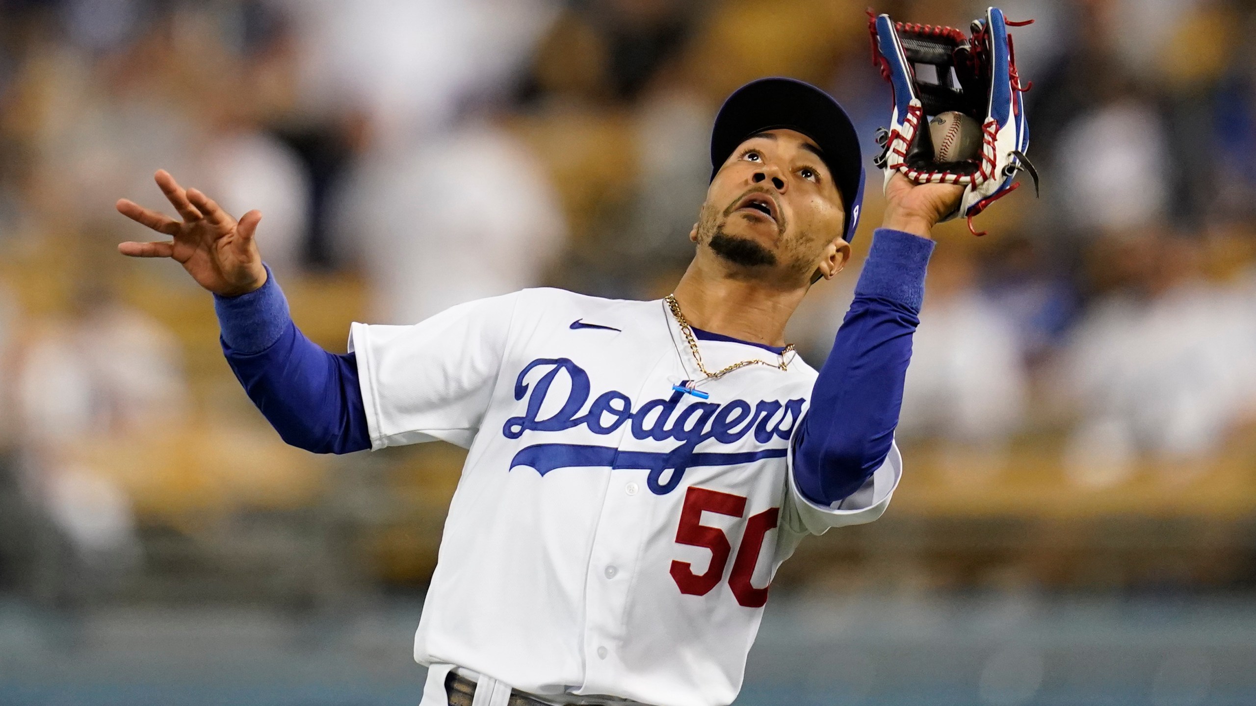 Los Angeles Dodgers right fielder Mookie Betts catches a fly ball hit by San Diego Padres' Tommy Pham during the ninth inning of a baseball game Sept. 30, 2021. (Ashley Landis/Associated Press)