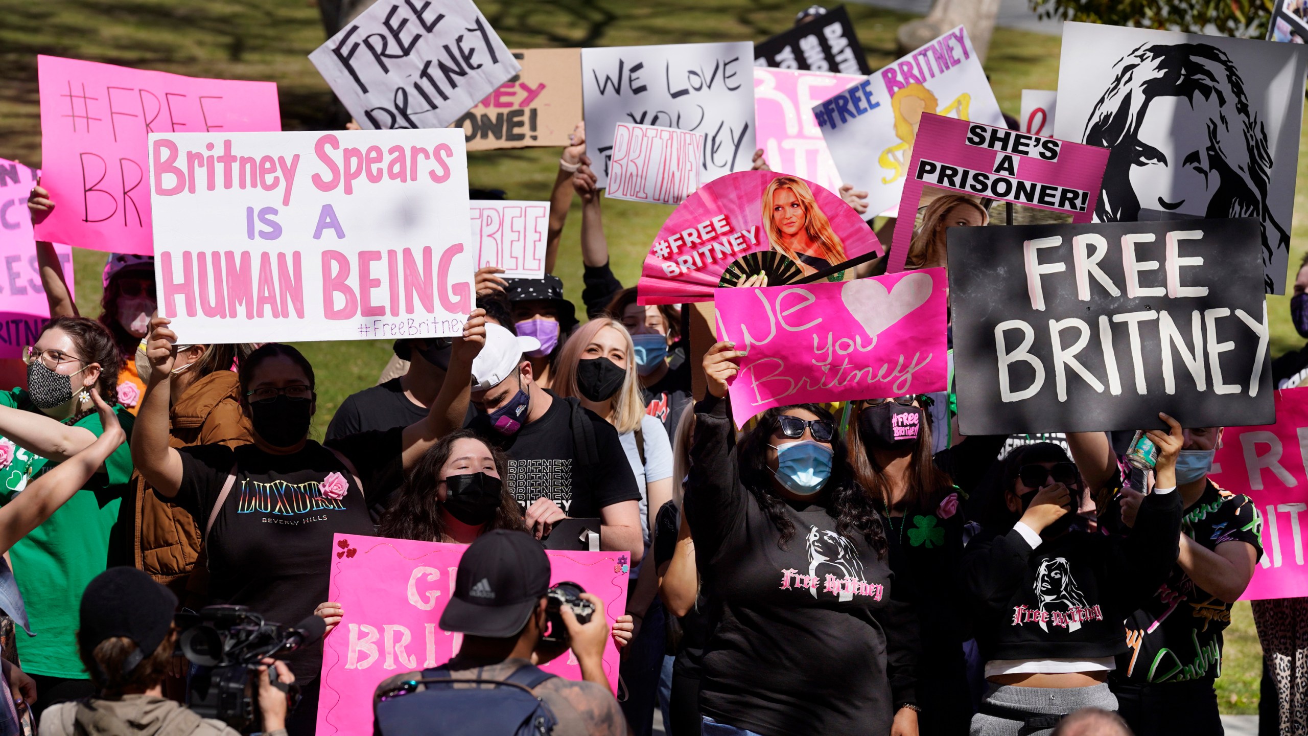 In this March 17, 2021 file photo Britney Spears fans hold signs outside a court hearing concerning the pop singer's conservatorship at the Stanley Mosk Courthouse, in Los Angeles. (Chris Pizzello/Associated Press)