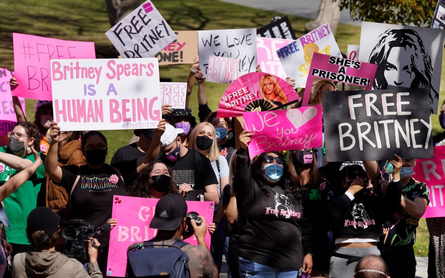 In this March 17, 2021 file photo Britney Spears fans hold signs outside a court hearing concerning the pop singer's conservatorship at the Stanley Mosk Courthouse, in Los Angeles. (Chris Pizzello/Associated Press)