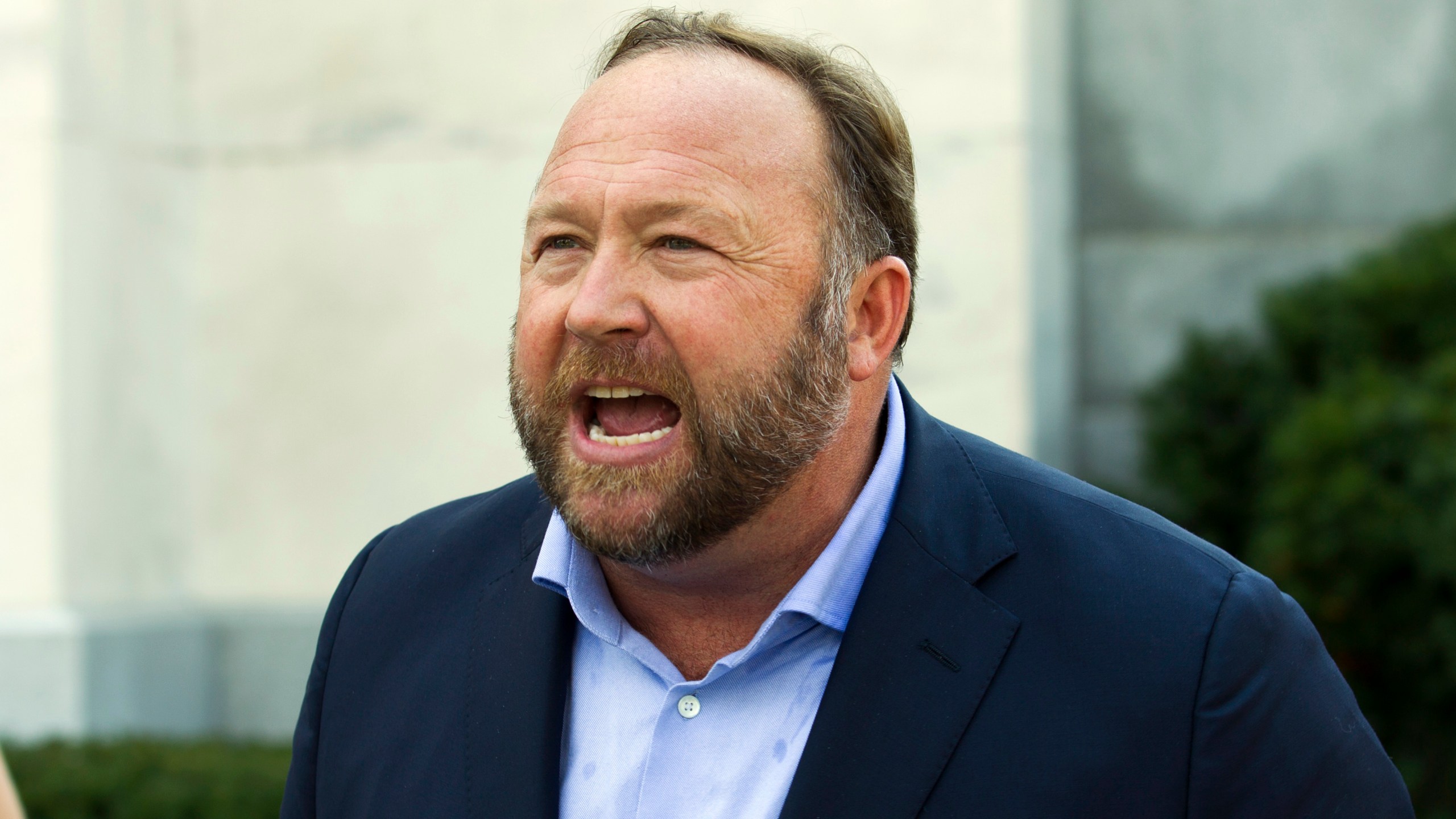 In this Sept. 5, 2018, file photo, Infowars host and conspiracy theorist Alex Jones speaks outside of the Dirksen building on Capitol Hill in Washington. A Texas judge has found Jones liable for damages in three defamation lawsuits brought by the parents of two children killed in the Sandy Hook Elementary School massacre over his claims that the shooting was a hoax. The rulings were issued on Monday, Sept. 27, 2021 and released on Thursday, Sept. 30, 2021. The cases now head to trial for juries to determine the amount of damages Jones and the other defendants will have to pay the families. (AP Photo/Jose Luis Magana, File)