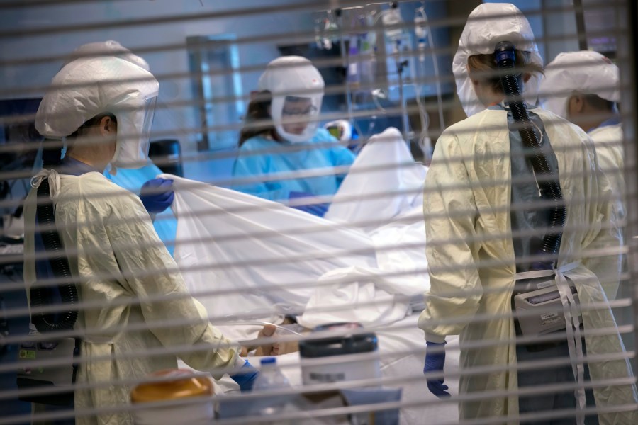 In this image provided by the University of Utah Health, medical professionals look after a COVID-19 patient in the intensive care unit on July 30, 2021, in Salt Lake City. (Charlie Ehlert/University of Utah Health via AP)