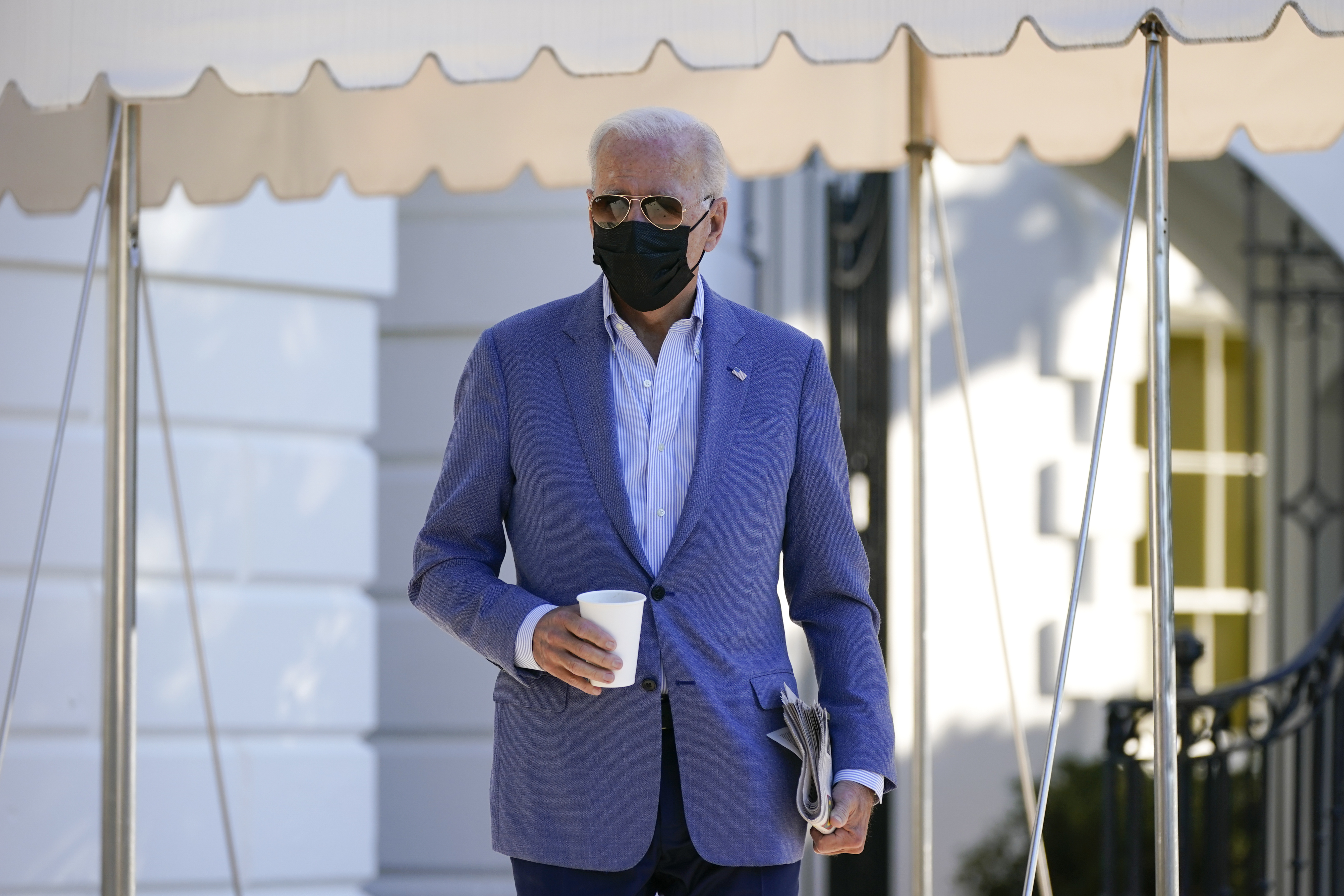 President Joe Biden walks over to speak with members of the press before boarding Marine One on the South Lawn of the White House, Saturday, Oct. 2, 2021, in Washington. Biden is spending the weekend at his home in Delaware. (AP Photo/Patrick Semansky)