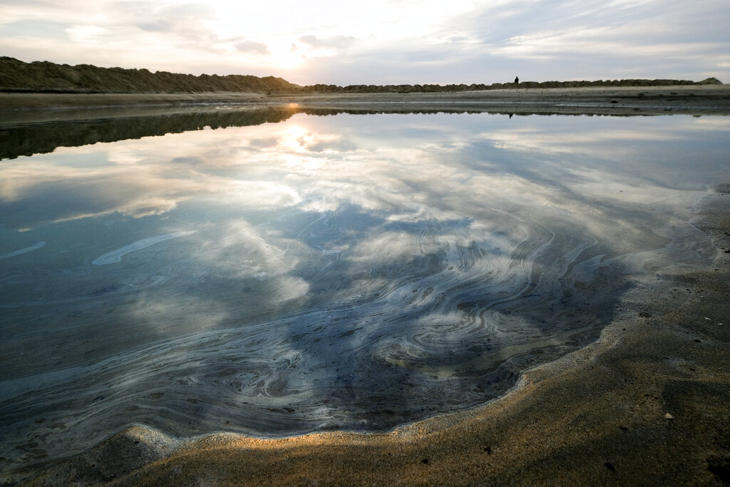 Oil floats on the water surface after an oil spill in Huntington Beach, Calif., on Monday, Oct. 4, 2021. (AP Photo/Ringo H.W. Chiu)