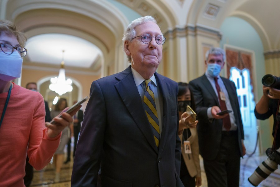 Senate Minority Leader Mitch McConnell, R-Ky., is surrounded by journalists as he walks to the Senate Chamber for a vote as Democrats look for a way to lift the debt limit without Republican votes, at the Capitol in Washington, Wednesday, Oct. 6, 2021. (AP Photo/J. Scott Applewhite)