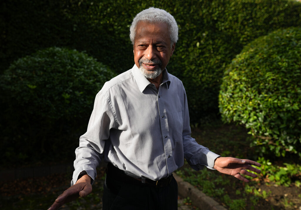 Tanzanian writer Abdulrazak Gurnah gestures as he poses for a photo at his home in Canterbury, England, Thursday, Oct. 7, 2021. (AP Photo/Frank Augstein)