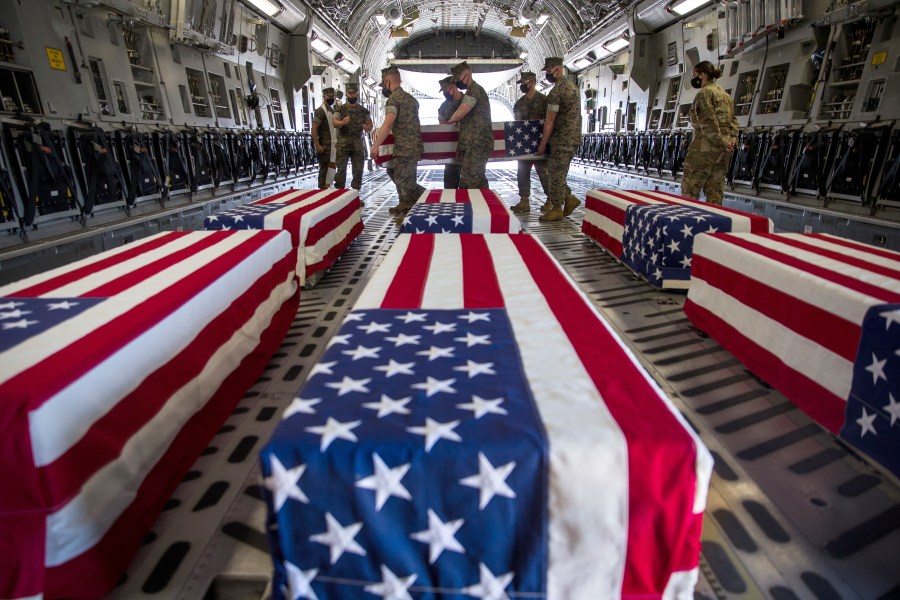 In this Aug. 12, 2020, file photo provided, by the U.S. Marine Corps, U.S. Marines and sailors carry a casket of the remains of one service personnel who died when their amphibious vehicle sank off the California coast, inside a U.S. Air Force C-17 Globemaster III at Marine Corps Air Station Miramar, in Calif. A new military investigation found coronavirus pandemic curtailed trainings in 2020 and contributed to nine service members drowning off the San Diego's coast. The findings were released Wednesday, Oct. 6, 2021 were from the latest investigation into the sinking of the amphibious assault vehicle on July 30, 2020. (Lance Cpl. Brendan Mullin/U.S. Marine Corps via AP, File)