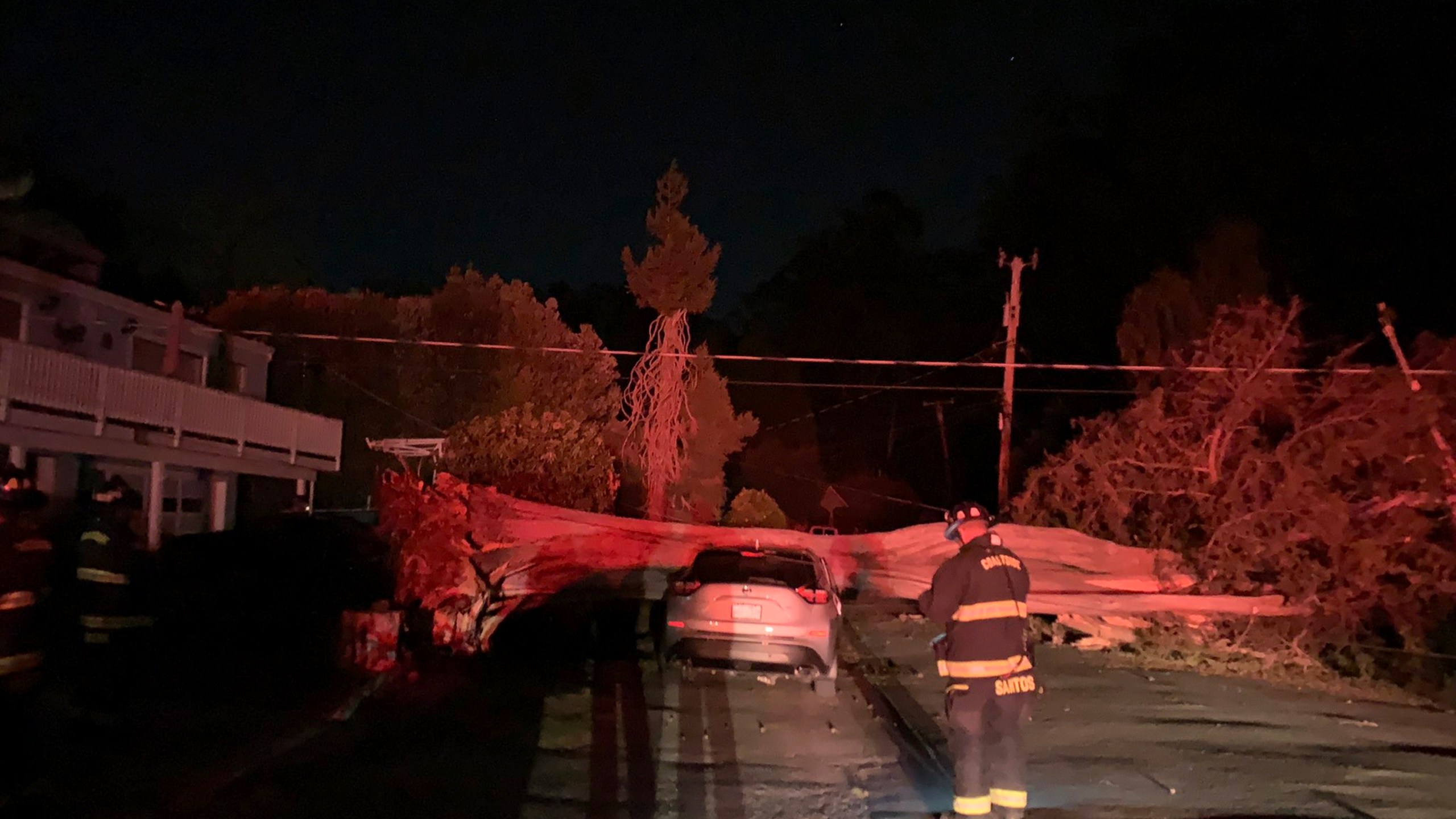 This early Monday, Oct. 11, 2021, photo provided by CalFire shows one of several vehicles damaged during a wind event in El Granada village in the coastal area of northern San Mateo County, Calif. (CalFire via AP)