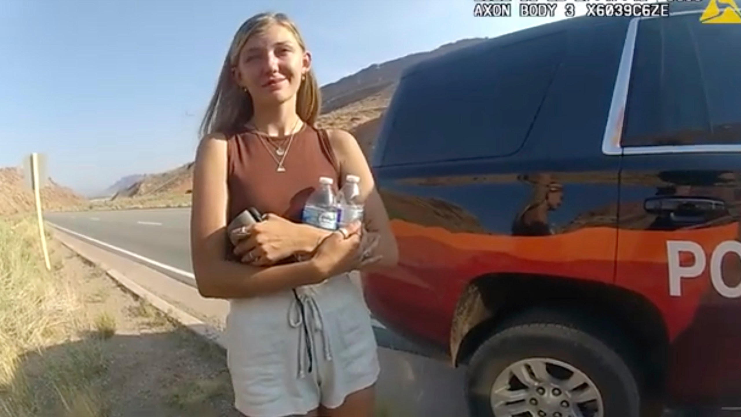 This police camera video provided by The Moab Police Department shows Gabrielle "Gabby" Petito talking to a police officer after police pulled over the van she was traveling in with her boyfriend, Brian Laundrie, near the entrance to Arches National Park on Aug. 12, 2021. Teton County Coroner Brent Blue is scheduled to announce the findings of Petito's autopsy at a news conference early Tuesday, Oct. 12. (The Moab Police Department via AP)