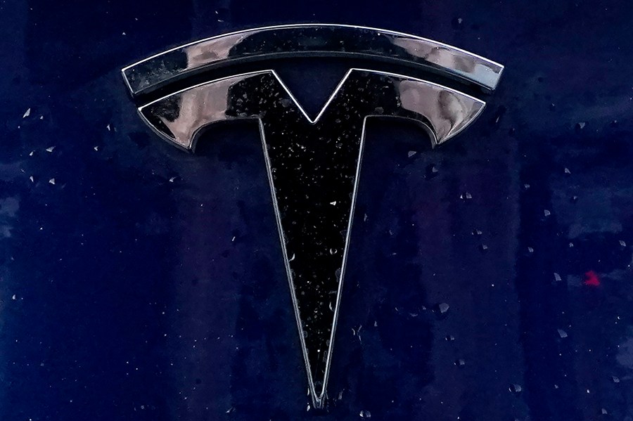 A Tesla electric vehicle emblem is affixed to a passenger vehicle on Feb. 21, 2021, in Boston. (AP Photo/Steven Senne, File)