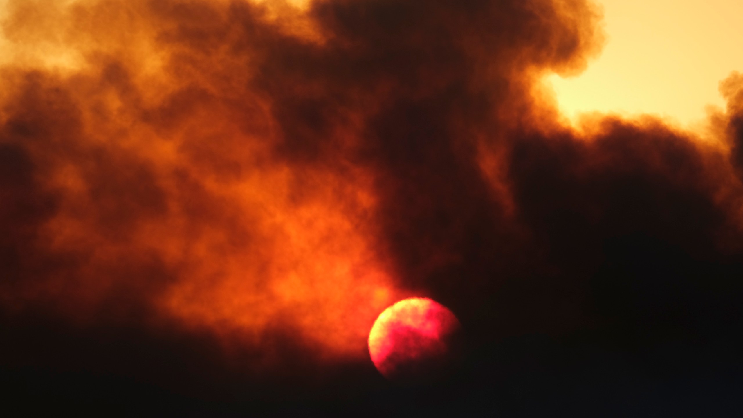 Smoke rises from a wildfire during the sunset Wednesday, Oct. 13, 2021, in Goleta, Calif. (AP Photo/Ringo H.W. Chiu)