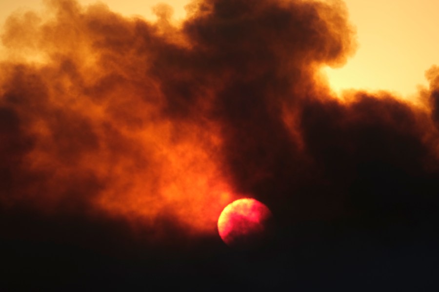 Smoke rises from a wildfire during the sunset Wednesday, Oct. 13, 2021, in Goleta, Calif. (AP Photo/Ringo H.W. Chiu)