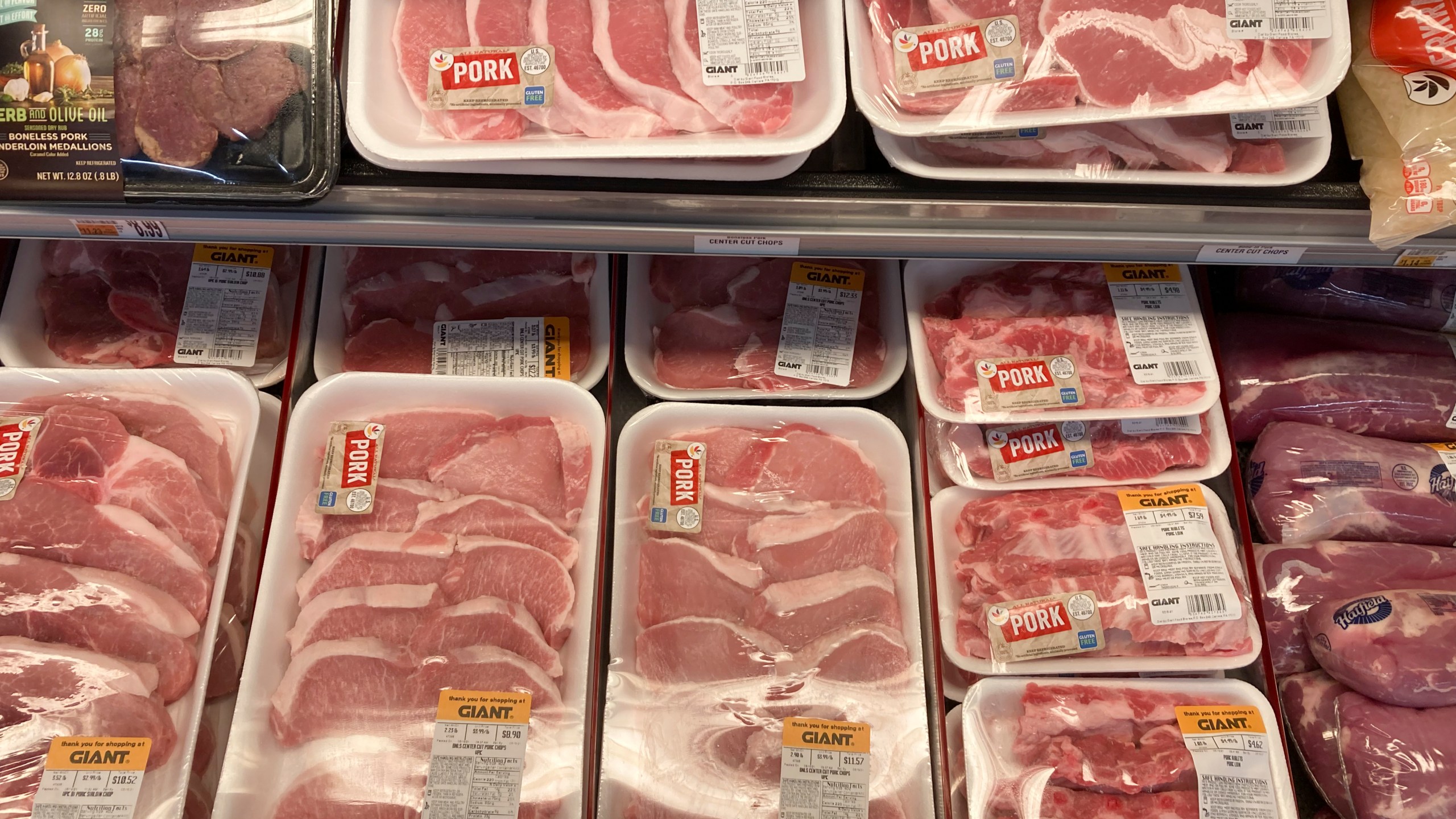 Shown are pork products at a grocery store in Roslyn, Pa., Tuesday, June 15, 2021. The Labor Department reported Thursday Oct. 14, that the monthly increase in its producer price index, which measures inflationary pressures before they reach consumers, was 0.5% for September compared to a 0.7% gain in August. (AP Photo/Matt Rourke)