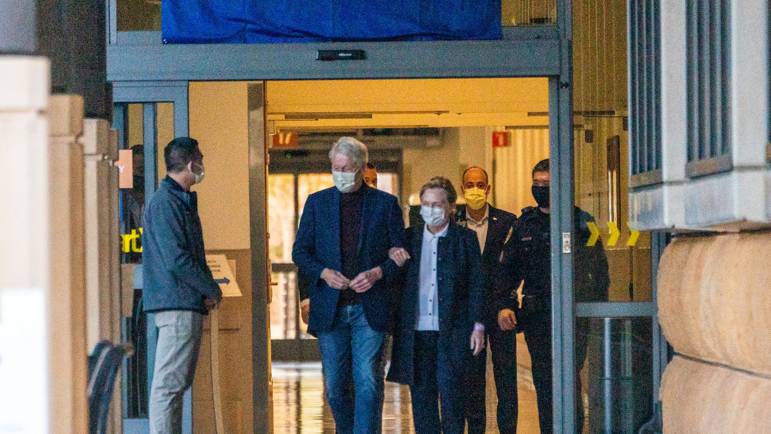 Former President Bill Clinton and former U.S. Secretary of State Hillary Clinton leave the University of California Irvine Medical Center in Orange, Calif., Sunday, Oct. 17, 2021. He was released after being treated for an infection and will head home to New York to continue his recovery, a spokesman said. (AP Photo/Damian Dovarganes)