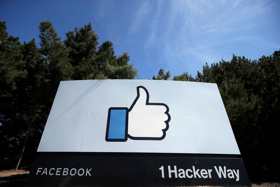 In this April 14, 2020 file photo, the thumbs up Like logo is shown on a sign at Facebook headquarters in Menlo Park, Calif. Facebook says it plans to hire 10,000 workers in the European Union over the next five years to work on a new computing platform. The company said in a blog post Sunday, Oct. 17, 2021 that those high-skilled workers will help build “the metaverse,” a futuristic notion for connecting people online that uses augmented and virtual reality. (AP Photo/Jeff Chiu, File)