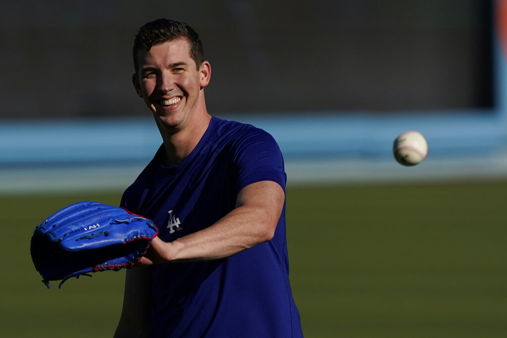 Los Angeles Dodgers starting pitcher Walker Buehler warms up during a workout ahead of Game 3 of baseball's National League Championship Series against the Atlanta Braves, Monday, Oct. 18, 2021, in Los Angeles. (AP Photo/Marcio Jose Sanchez)