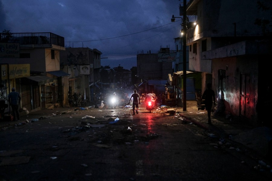 A man walks through the Petion-Ville market during a general strike in Port-au-Prince, Monday, Oct. 18, 2021. (AP Photo/Matias Delacroix)