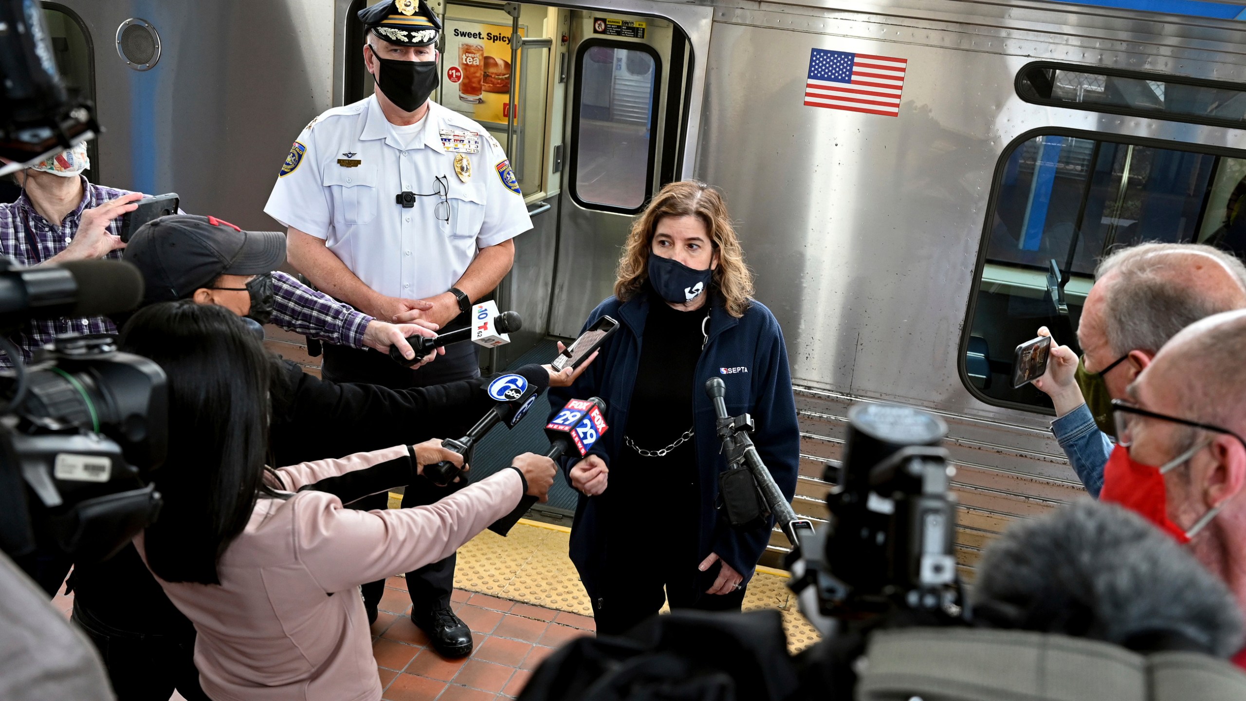 SEPTA General Manager Leslie Richards speaks during a news conference as SEPTA Transit Police Chief Thomas Nestel III stands behind her on an El platform at the 69th Street Transportation Center, Monday, Oct. 18, 2021, in Philadelphia, following a brutal rape on the El, as other riders watched, over the weekend. They discussed the emergency call boxes on SEPTA trains and how to properly contact police from the trains. (Tom Gralish/The Philadelphia Inquirer via AP)