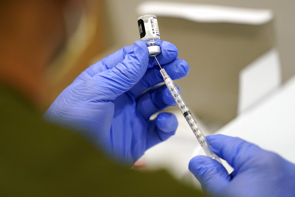 In this Oct. 5, 2021, file photo a healthcare worker fills a syringe with the Pfizer COVID-19 vaccine at Jackson Memorial Hospital in Miami. (AP Photo/Lynne Sladky, File)