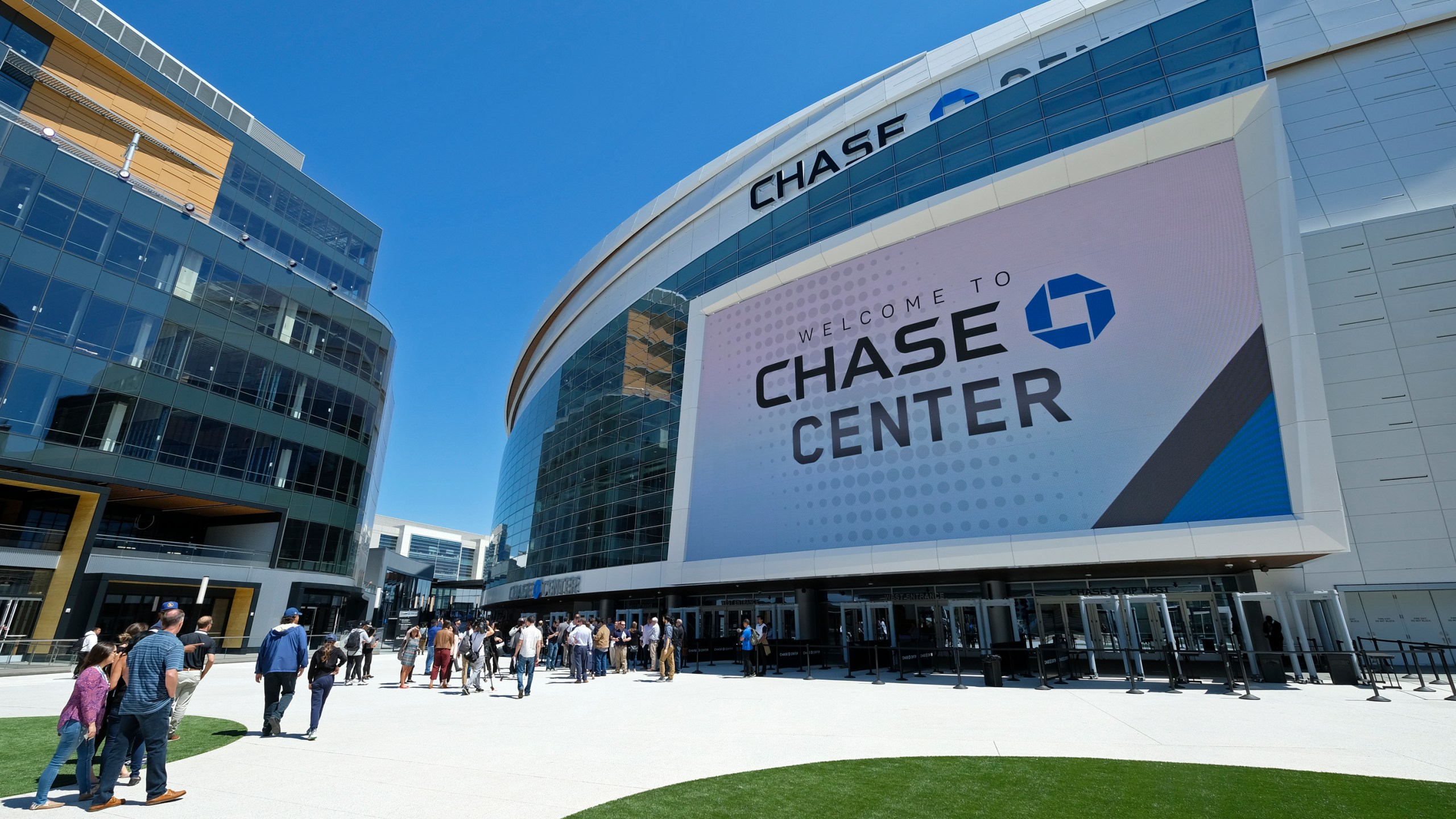 In this Aug. 26, 2019, file photo, people walk outside the Chase Center in San Francisco. (Eric Risberg/Associated Press)