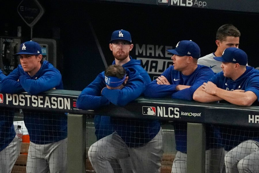 Los Angeles Dodgers watch the ninth inning from their dugout against the Atlanta Braves in Game 6 of baseball's National League Championship Series Saturday, Oct. 23, 2021, in Atlanta. (AP Photo/John Bazemore)