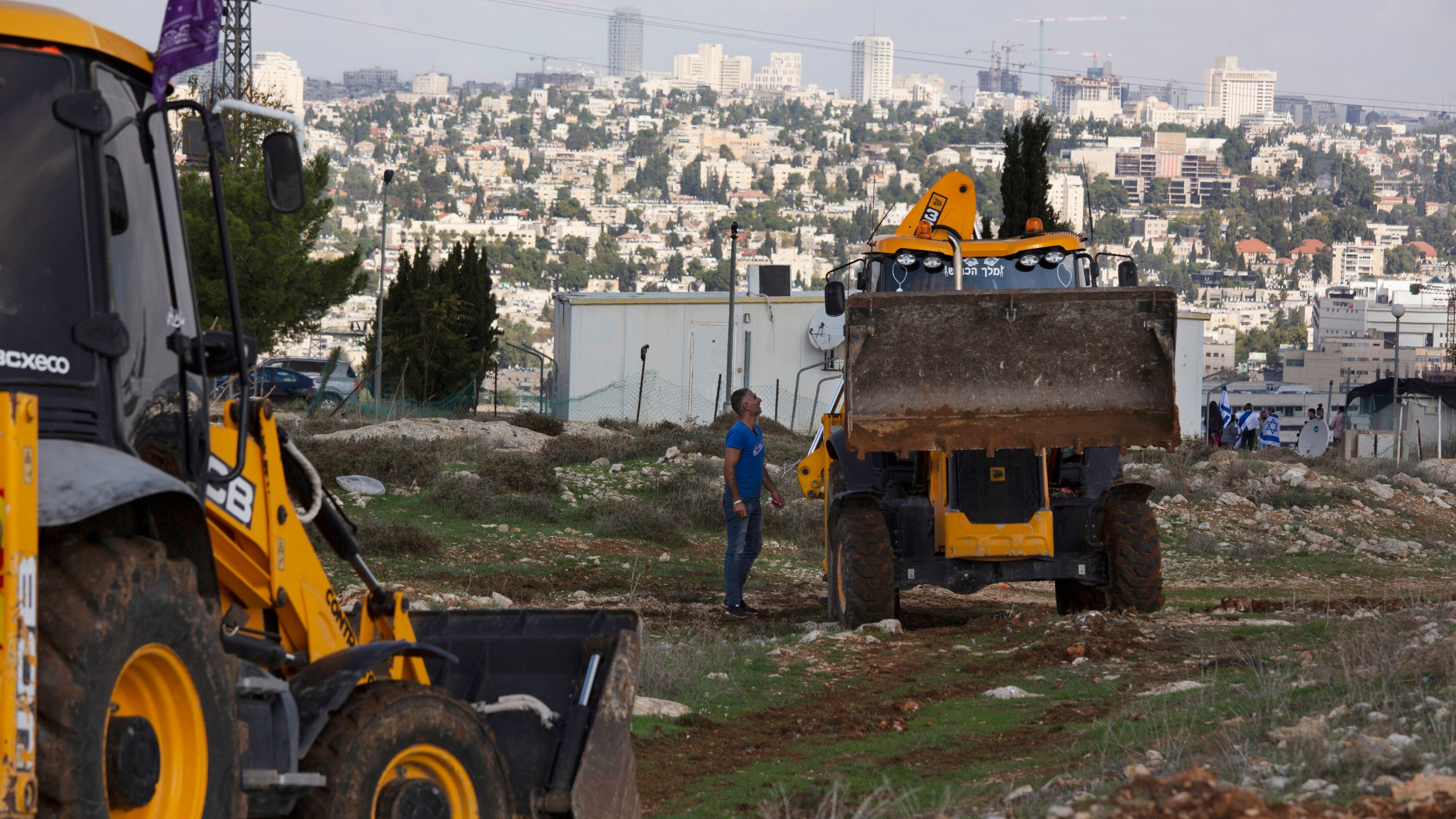 In this Nov. 16, 2020 file photo, workers take a break before European Union officials visit the construction site for the Givat Hamatos Israeli settlement, in Jerusalem.(AP Photo/Maya Alleruzzo, File)