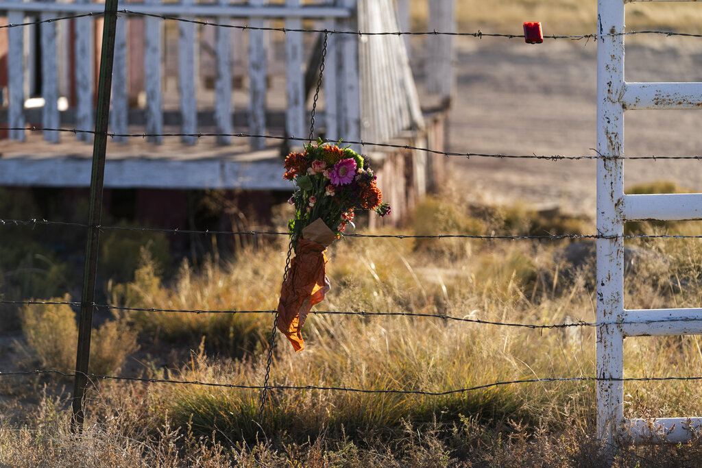 A bouquet of flowers is left to honor cinematographer Halyna Hutchins outside the Bonanza Creek Ranch in Santa Fe, N.M., Sunday, Oct. 24, 2021. (AP Photo/Jae C. Hong)