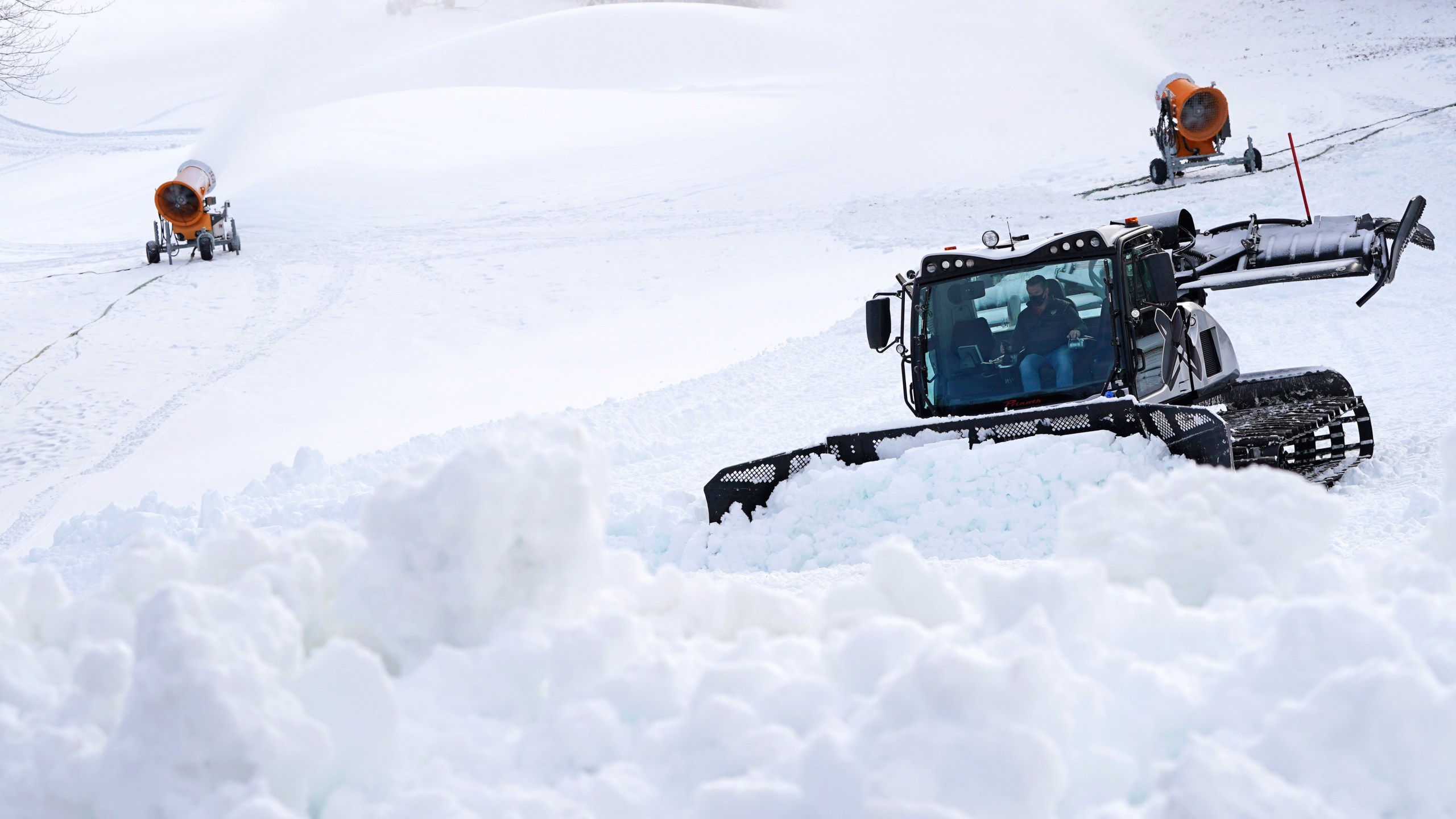 In this Dec. 16, 2020 file photograph, a snow cat grooms a trail at McIntyre Ski Area, in Manchester, N.H. Ski areas across the country are preparing for the 2021 season. (AP Photo/Charles Krupa, File)