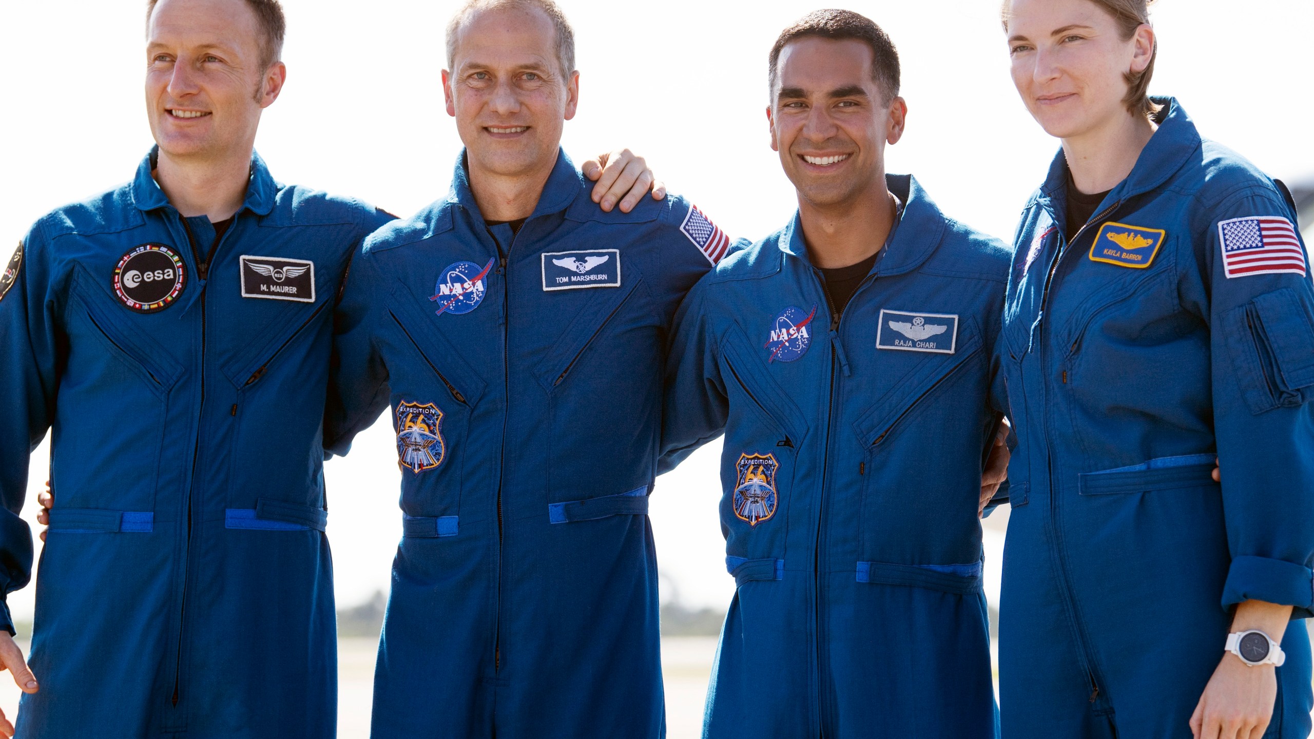 In this Tuesday, Oct. 26, 2021 photo provided by NASA, from left, European Space Agency astronaut Matthias Maurer of Germany, and NASA astronauts Tom Marshburn, Raja Chari, and Kayla Barron gather for a photo after arriving at the Kennedy Space Center in Cape Canaveral, Fla. (Joel Kowsky/NASA via AP)