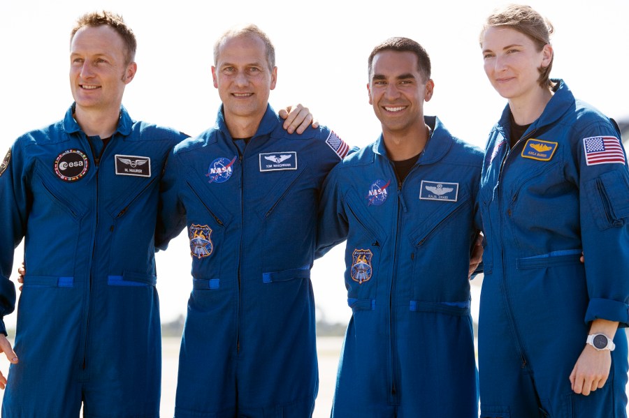 In this Tuesday, Oct. 26, 2021 photo provided by NASA, from left, European Space Agency astronaut Matthias Maurer of Germany, and NASA astronauts Tom Marshburn, Raja Chari, and Kayla Barron gather for a photo after arriving at the Kennedy Space Center in Cape Canaveral, Fla. (Joel Kowsky/NASA via AP)